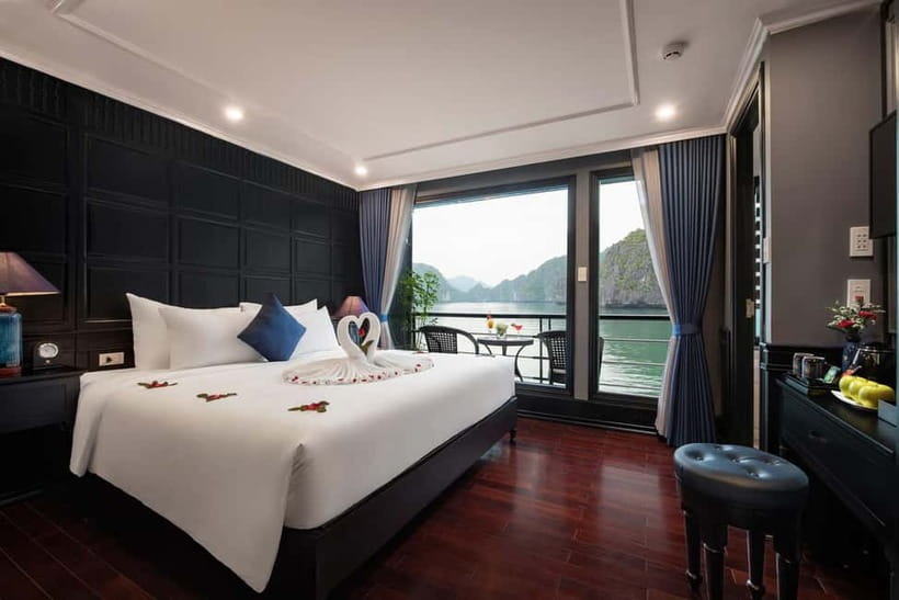 Hanoi: 2-Day Halong-Lan Ha Bay BEST SELLER 5<em> cruise balcony – Key points at a glance’ /></p>
<ul>
<li><strong>Private balcony junior suite:</strong> Sleep in an air-conditioned ensuite cabin with a balcony and bay views.</li>
<li><strong>Two bays in one trip:</strong> The route covers Halong Bay and Lan Ha Bay, with stops selected according to conditions.</li>
<li><strong>Kayak or bamboo boat:</strong> Explore Dark and Bright Cave, Ba Trai Dao Beach, or the Tra Bau area.</li>
<li><strong>Sunset spring-roll lesson:</strong> Learn a classic Vietnamese dish during a cooking demonstration onboard.</li>
<li><strong>Early start on day two:</strong> Tai chi begins at 6:00 a.m., followed by breakfast and another outdoor activity.</li>
<li><strong>Hanoi transport included:</strong> Limousine transfers run from Hanoi Old Quarter, with pickup also available from Tam Coc and Trang An.</li>
</ul>
<h2 id="a-balcony-cabin-with-a-changing-view">A balcony cabin with a changing view</h2>
<p><img width="820" height="461" decoding="async" src=