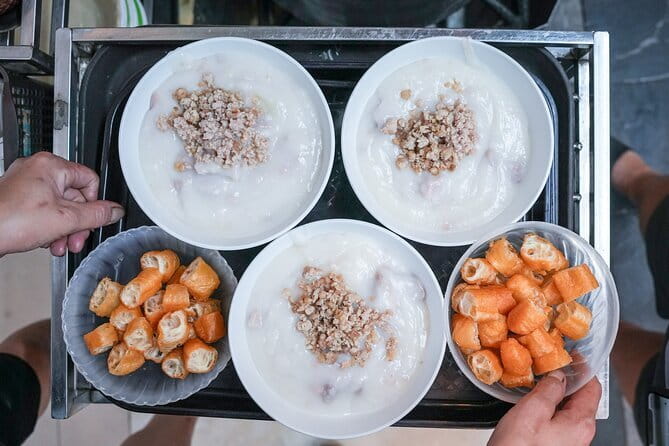 Old Quarter Food Tour in Hanoi - Dong Xuan Market with a guide beside you